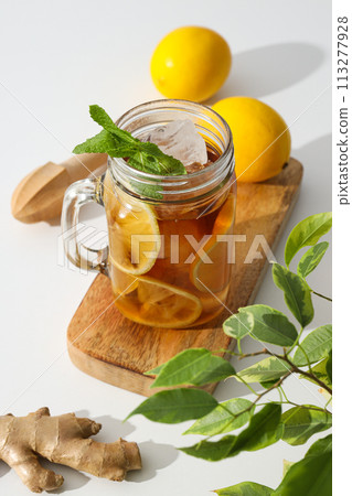 A glass of cold tea with fresh orange slices 113277928