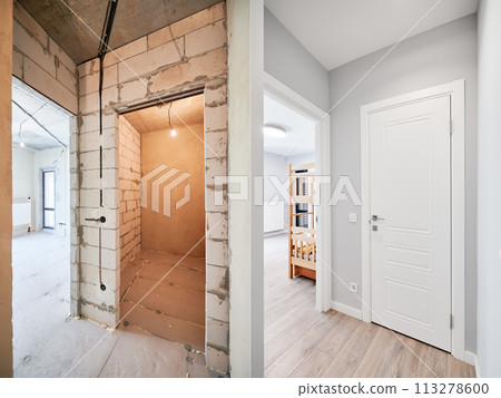Old apartment with brick walls and new renovated flat doors, children room and elegant interior design. Comparison of apartment before and after restoration. Home renovation concept. 113278600