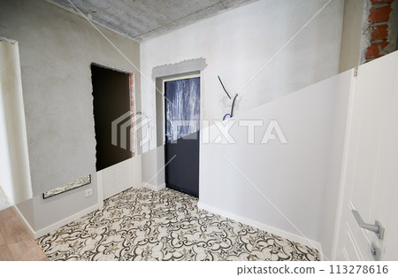 Modern apartment with doorways before and after refurbishment. Comparison of old flat and new place with white walls and modern interior design. Concept of home renovation. 113278616