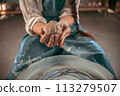 Master potter sculpts mold for jug with his hands 113279507