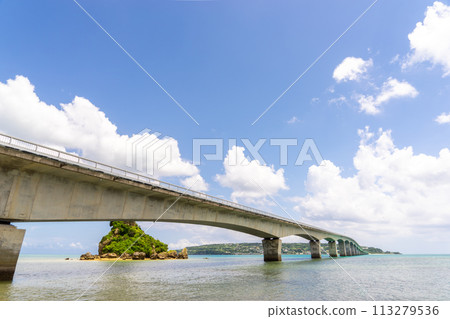 [Okinawa Prefecture] A clear, blue summer sky and Kouri Bridge 113279536