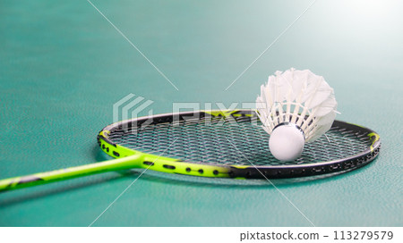 White badminton shuttlecocks and badminton rackets on green floor indoor badminton court soft and selective focus on shuttlecocks and the rackets White badminton shuttlecocks and badminton rackets on green floor indoor badminton court soft and selective focus on shuttlecocks and the rackets 113279579