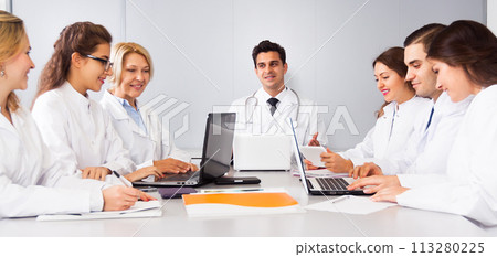 Meeting of doctors in the conference room at the table 113280225