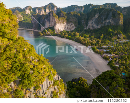 An aerial view of a Railay beach of water surrounded by mountains An aerial view of a Railay beach of water surrounded by mountains 113280262