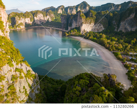An aerial view of a Railay beach of water surrounded by mountains An aerial view of a Railay beach of water surrounded by mountains 113280266