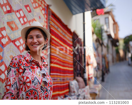 female summer travel to Antalya, Turkey. young asian woman in red dress walk through old town Kalechi , female tourist traveler discover interesting places and popular tourist traditional carpet female summer travel to Antalya, Turkey. young asian woman in red dress walk through old town Kalechi , female tourist traveler discover interesting places and popular tourist traditional carpet 113281003