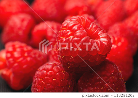 Close-up of fresh delicious raspberries in macro photography. Delicious berries vitamins and healthy food 113281202