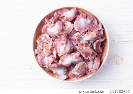 Raw chicken giblets gizzard ( stomach ) , meat background 113282805