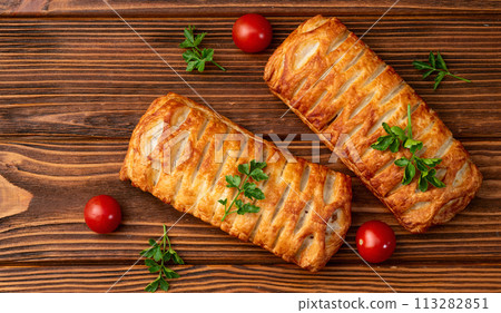 Golden Puff pastry stuffed with sausage and cheese 113282851