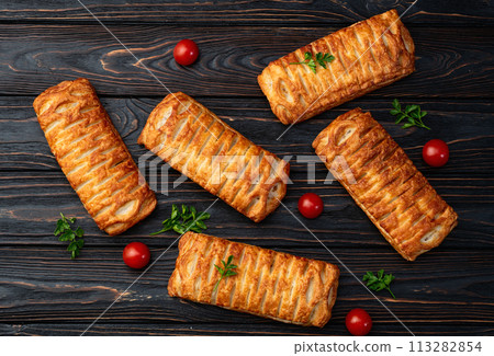 Golden Puff pastry stuffed with sausage and cheese 113282854