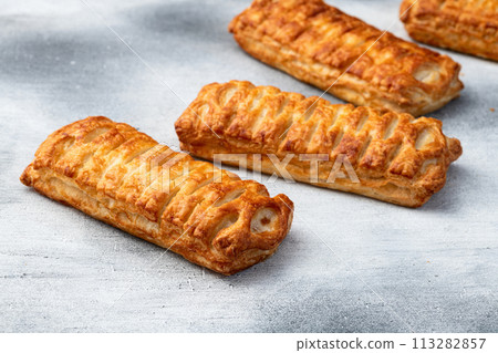 Golden Puff pastry stuffed with sausage and cheese 113282857