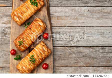 Golden Puff pastry stuffed with sausage and cheese 113282858