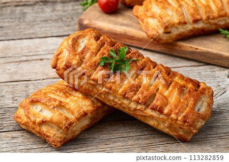 Golden Puff pastry stuffed with sausage and cheese 113282859