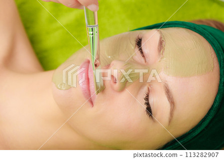 Woman having algae mud mask on face Woman having algae mud mask on face 113282907