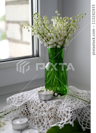 Composition of lily of the valley. Spring concept. A gift to a woman. Composition of lily of the valley. Spring concept. A gift to a woman. 113282935