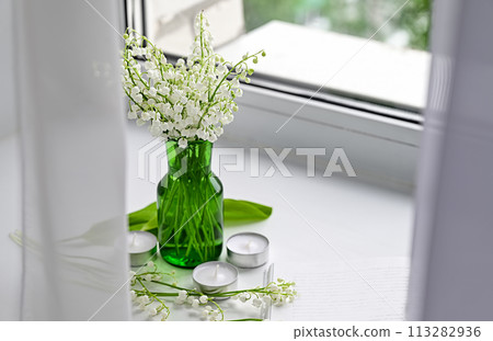 Composition of lily of the valley. Spring concept. A gift to a woman. Composition of lily of the valley. Spring concept. A gift to a woman. 113282936