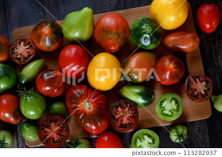 Fresh sliced tomatoes on black background, copy space 113282937