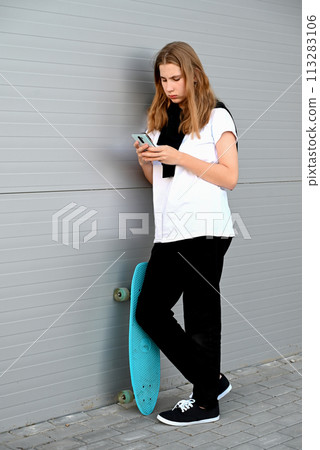 Beautiful and blonde girl practicing long board on the road Beautiful and blonde girl practicing long board on the road 113283106