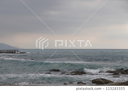A lone figure in front of foam waves and a historic mountain in Alanya, November 2021. A lone figure in front of foam waves and a historic mountain in Alanya, November 2021. 113283355