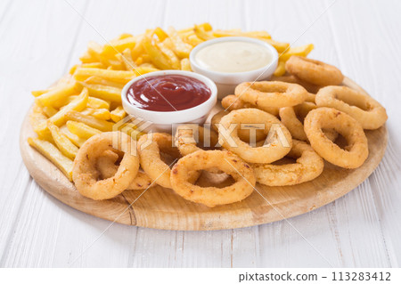 French fries and onion rings with sauces French fries and onion rings with sauces 113283412