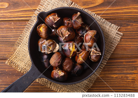 Tasty fried chestnut snack background 113283488