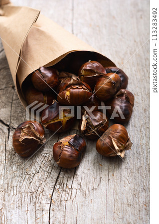 Tasty fried chestnut snack background Tasty fried chestnut snack background 113283492