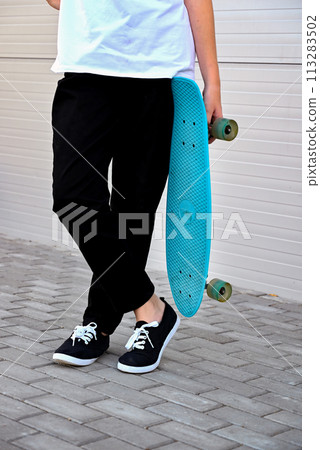 Beautiful and blonde girl practicing long board on the road 113283502