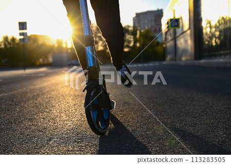 Beautiful and blonde girl practicing long board on the road 113283505