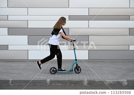 Beautiful and blonde girl practicing long board on the road 113283508