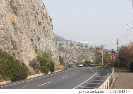 Road to Alanya and Cleopatra beach, sheer cliffs, Antalya, Turkey. 113284254