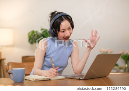 Successful businesswoman has fun selling online and delivering packages in her home office Woman checking orders on notebook and laptop, SME business concept 113284590