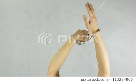 hands in handcuffs symbolizing the lack of freedom of action hands in handcuffs symbolizing the lack of freedom of action 113284966