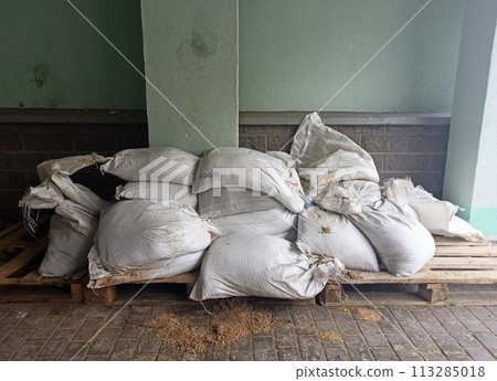 Bags of rice in the warehouse of the factory. Agriculture and farming. Bags of rice in the warehouse of the factory. Agriculture and farming. 113285018