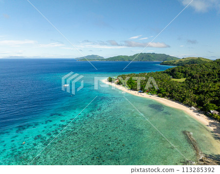 Sandy beach with clear sea water and waves. Blue sky and clouds. Logbon Island. Romblon, Philippines. 113285392