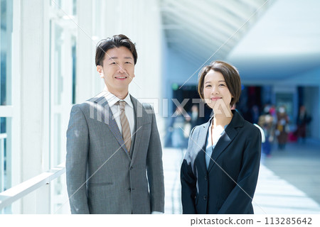 Middle-aged men and women in suits 113285642