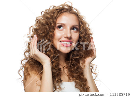 Cheerful good-looking redhead woman with clean skin, curly hairstyle and natural make-up. 113285719