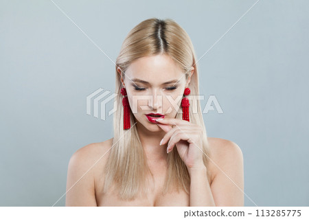 Attractive young blonde lady with fresh clear skin and long smooth straight hairstile Attractive young blonde lady with fresh clear skin and long smooth straight hairstile 113285775