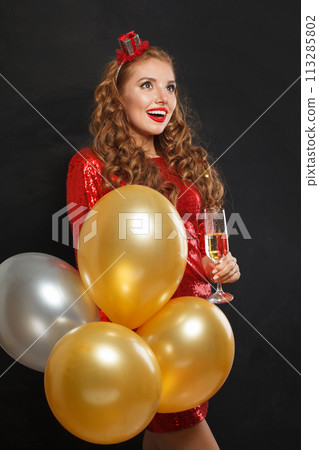 Nice happy surprised woman with makeup and hairstyle wearing red shiny sequins dress holding party Nice happy surprised woman with makeup and hairstyle wearing red shiny sequins dress holding party 113285802