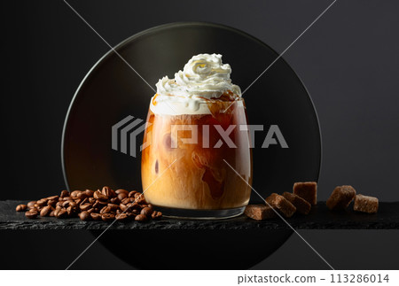 Iced coffee with whipped cream and caramel sauce. 113286014