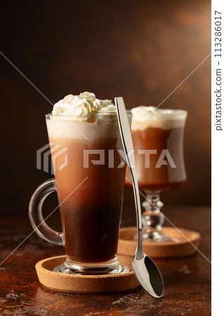 Creamy milk chocolate drinks with whipped cream. Creamy milk chocolate drinks with whipped cream. 113286017