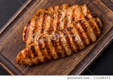 Delicious fresh grilled chicken fillet with spices and herbs Delicious fresh grilled chicken fillet with spices and herbs 113286372