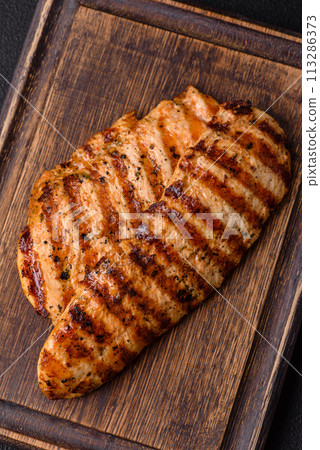 Delicious fresh grilled chicken fillet with spices and herbs 113286373