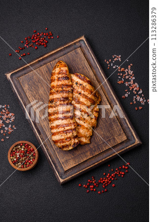 Delicious fresh grilled chicken fillet with spices and herbs Delicious fresh grilled chicken fillet with spices and herbs 113286379