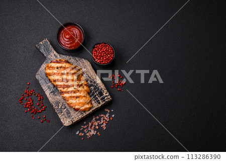 Delicious fresh grilled chicken fillet with spices and herbs Delicious fresh grilled chicken fillet with spices and herbs 113286390