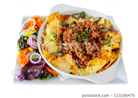 Mexican corn and vegetable salad with cheese and nachos chips in a white dish. Mexican food concept. On a white isolated background. 113286470