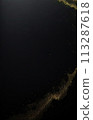 Dynamic digital wave of black particles with shining star dots, creating an abstract black background. 113287618
