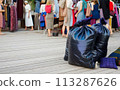 Large pile of garbage and textile waste in black bags for recycling, background and copyspace 113287626