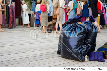Large pile of garbage and textile waste in black bags for recycling, background and copyspace Large pile of garbage and textile waste in black bags for recycling, background and copyspace 113287626