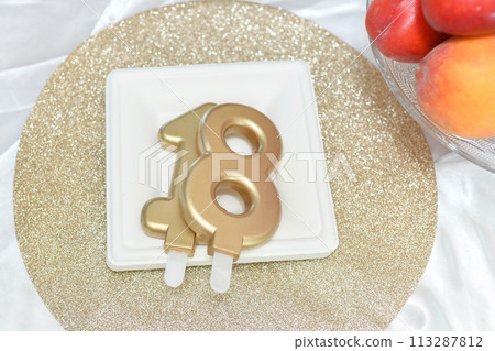 Candles number eighteen on a cake plate 113287812