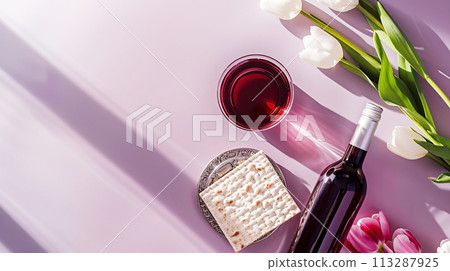 Jewish holiday Passover, Passover celebrations, traditional kosher food. Matzo, red kosher wine, beautiful spring tulips, purple pastel simple background, top view Jewish holiday Passover, Passover celebrations, traditional kosher food. Matzo, red kosher wine, beautiful spring tulips, purple pastel simple background, top view 113287925